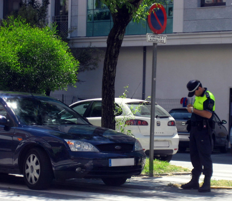 Andalucia by car: police officer fining a car