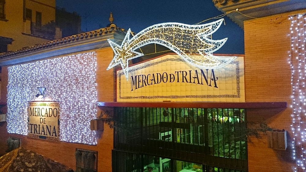 Visit Seville in winter - Triana market decorated with Christmas lights